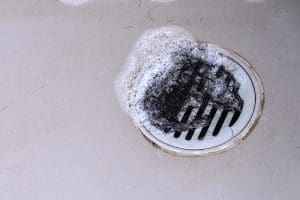 Hair clump in bath drain while taking a shower.