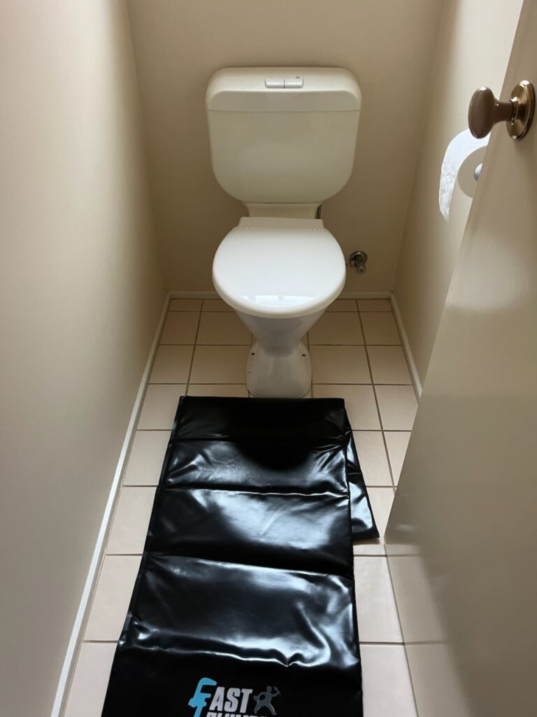 Old outdated plastic pan and cistern before toilet installation in Ringwood